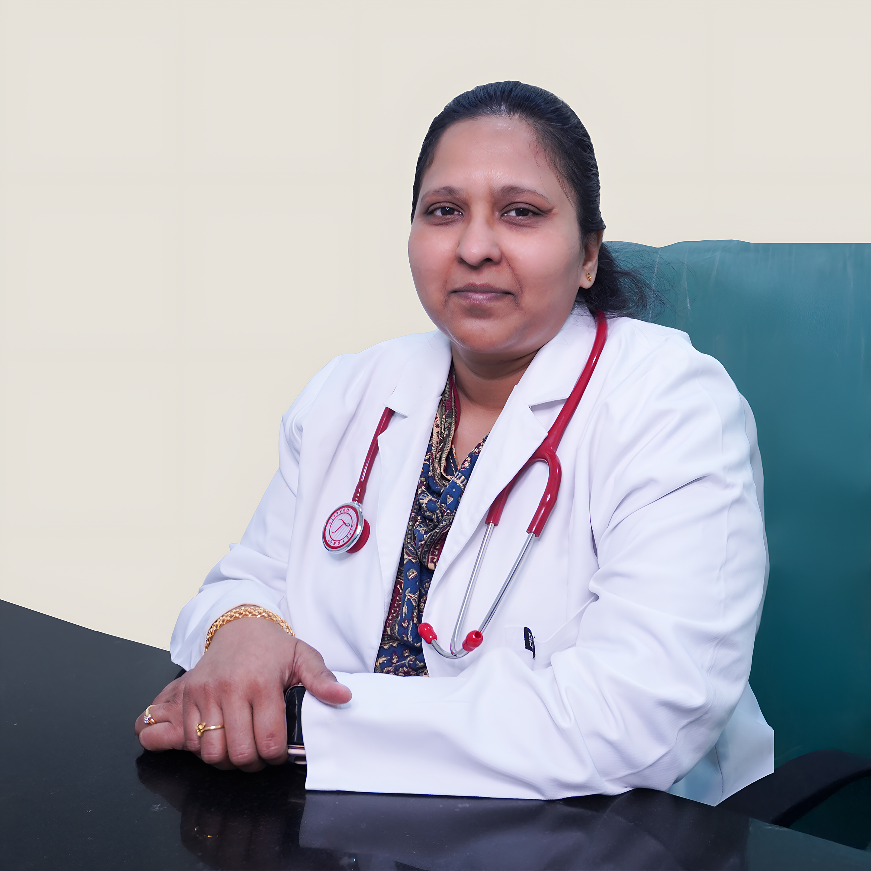 Portrait of Dr. Gona Sirisha Grace, a female pulmonologist wearing a white coat and stethoscope, smiling, vertical rectangle photo